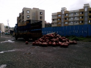 Bharat Gas cylinder heap on the road near the delivery truck